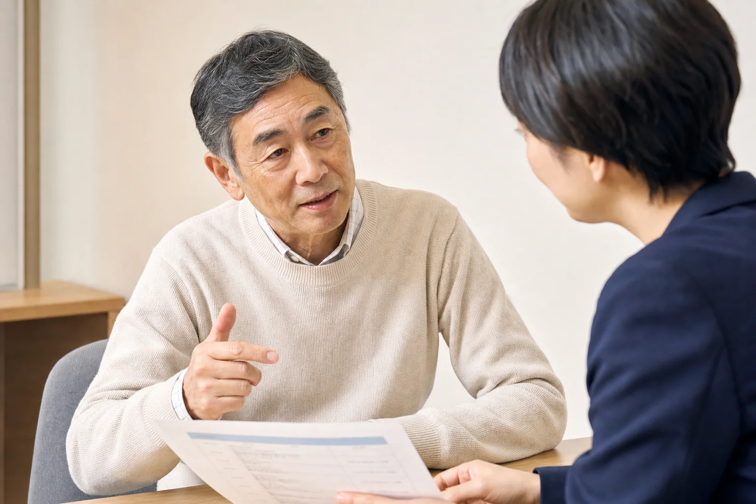 コーディネーターと向き合い求人票を確認しながら相談している60代の様子